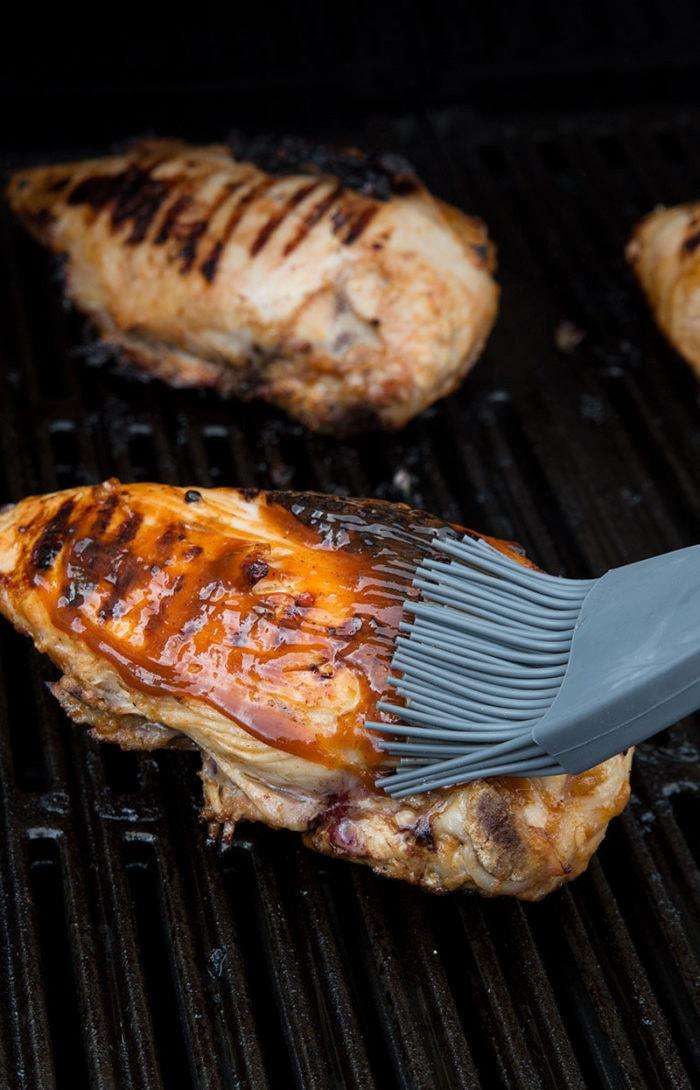 Basting Chicken with Low Carb Barbecue Chicken Marinade.